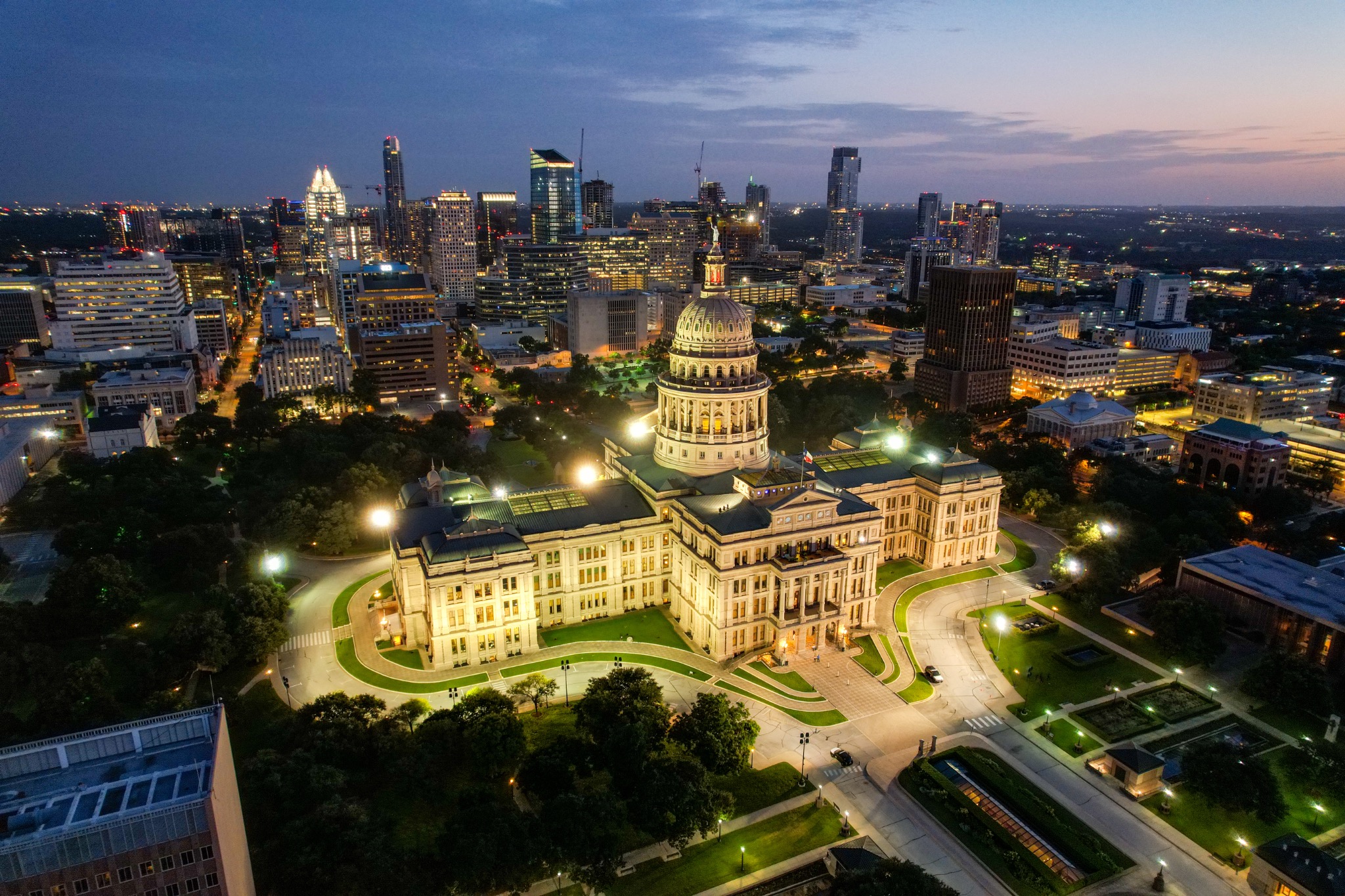 Aerial view of the Texas Capitol and Austin skyline at dusk
